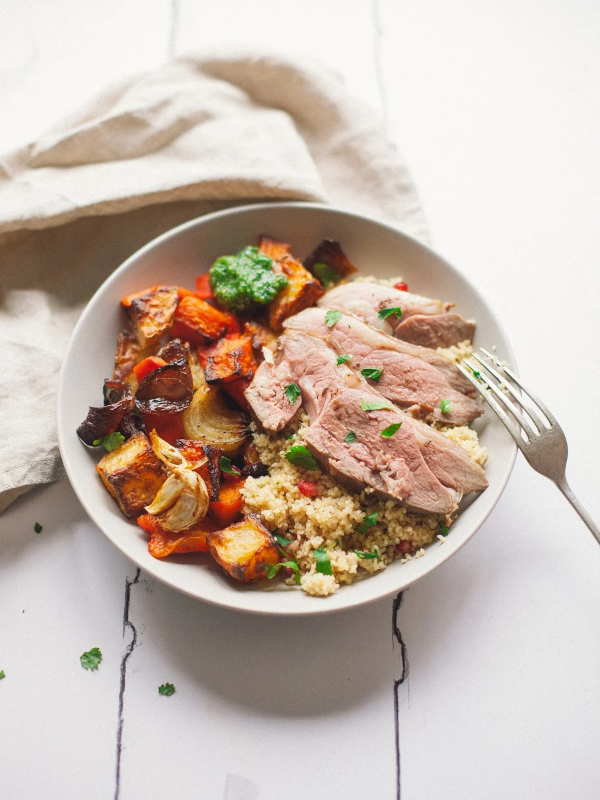 Sous-vide garlic and rosemary lamb with pesto roasted vegetables & couscous